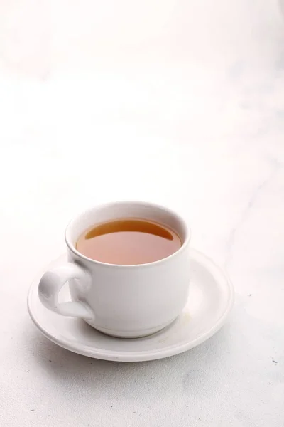 a cup of black tea on light background