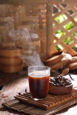 coffee cup with cinnamon sticks on wooden table