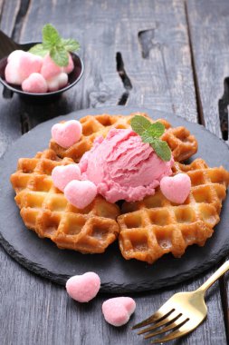 ice cream with fresh berries and mint on wooden background