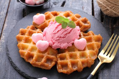 ice cream with fresh berries and mint on wooden background