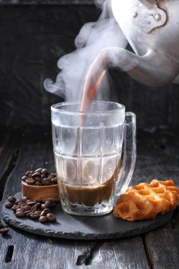 coffee cup with tea and chocolate on wooden background