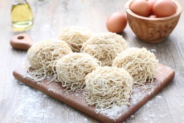 Tahta masada çiğ makarna ve yumurta topları. 