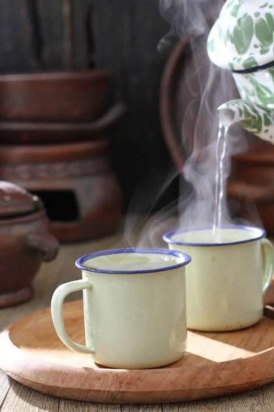 stock image green cup of tea on table 