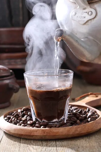 木製の背景に煙と豆とコーヒーカップ — ストック写真
