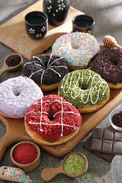 Разнообразные Шоколадные Пончики Деревянной Доске — стоковое фото