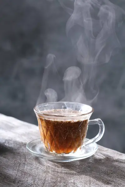 cup with hot coffee with steam and smoke.