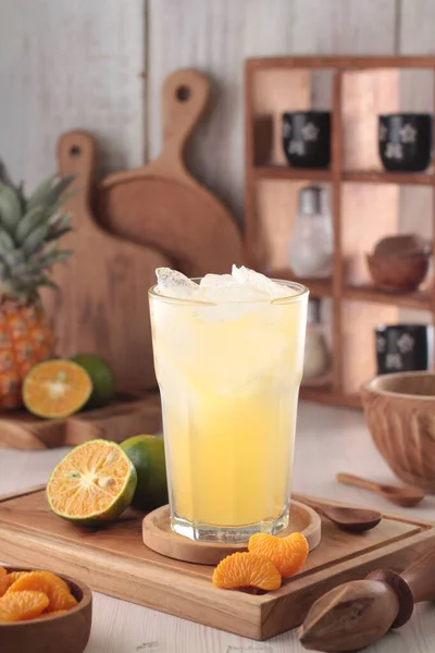 木のテーブルに氷とレモンが付いている冷たいオレンジ ジュースのガラス — ストック写真