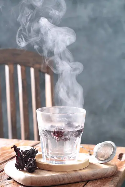 tea with ice in a cup on a wooden table