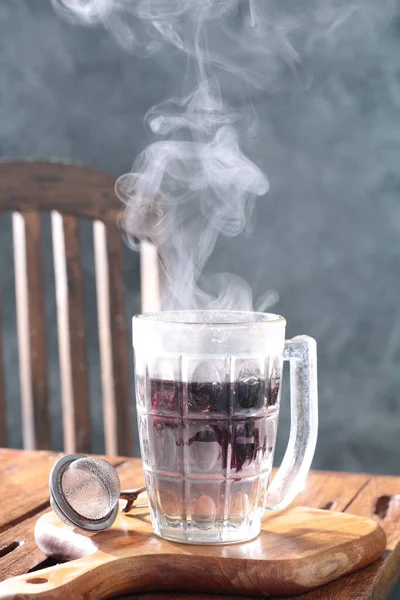 cup with black tea and ice