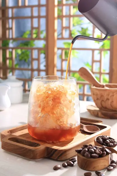 iced coffee with ice and coffee beans