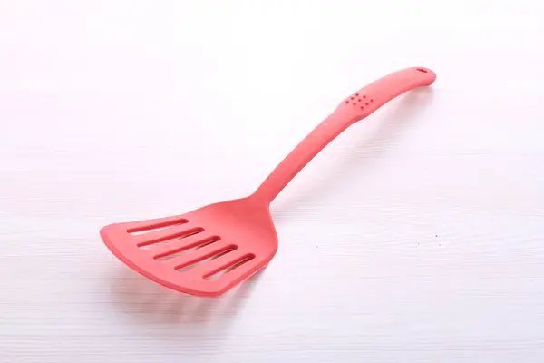 plastic kitchen utensils on white background