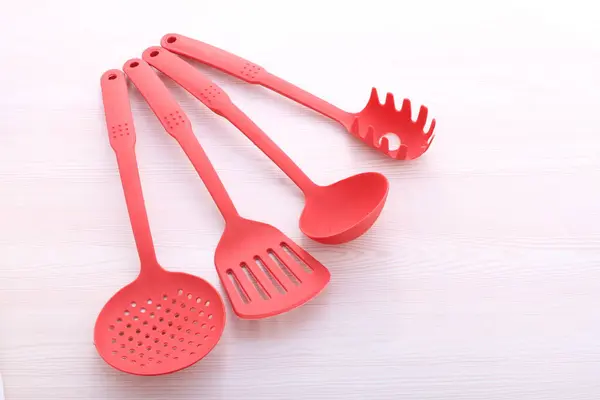 red plastic cutlery on white background