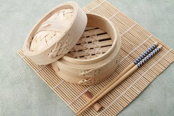 traditional chinese bamboo steamer on wooden table