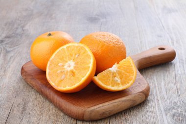 fresh orange fruit on wood