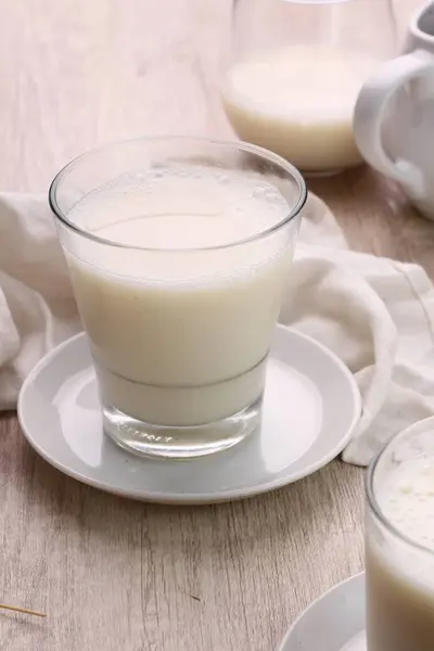 a glass of delicious milk with cream