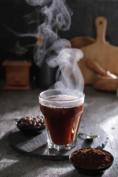 hot coffee with smoke on wooden table