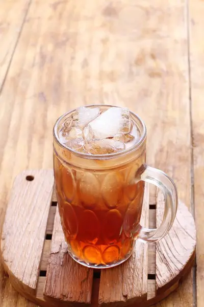 iced glass tea and ice cube with wood background