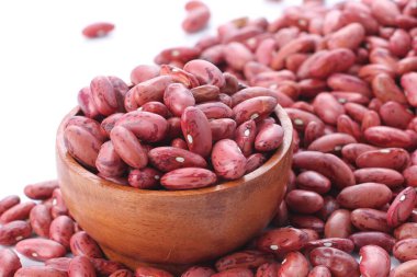 Beyaz bir yüzeyde bir kase kırmızı fasulye.