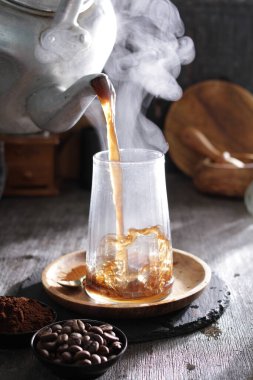 Bardağa doldurulan bir bardak kahve.