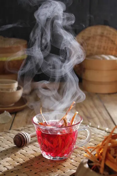 a cup of tea with smoke rising out of it