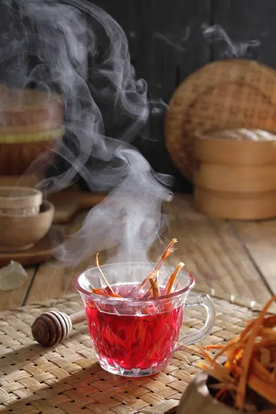 a cup of tea with smoke coming out of it