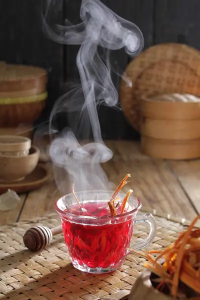 a cup of tea with smoke rising out of it