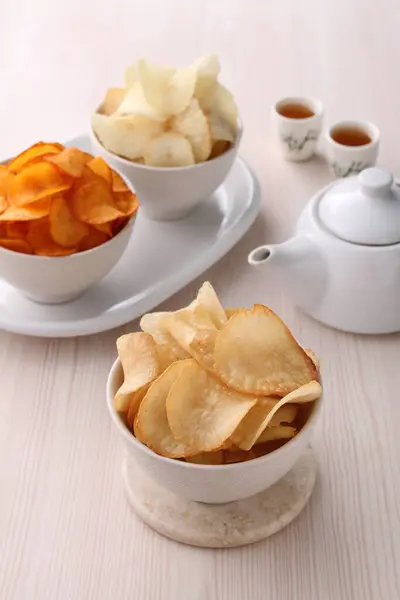 plate with delicious apple chips and apple chips on table