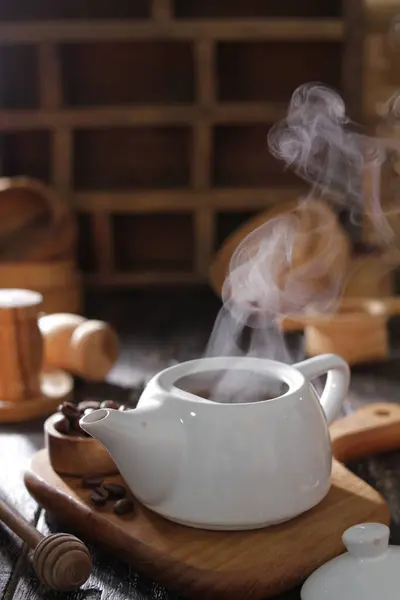 hot coffee cup with steam and cinnamon sticks
