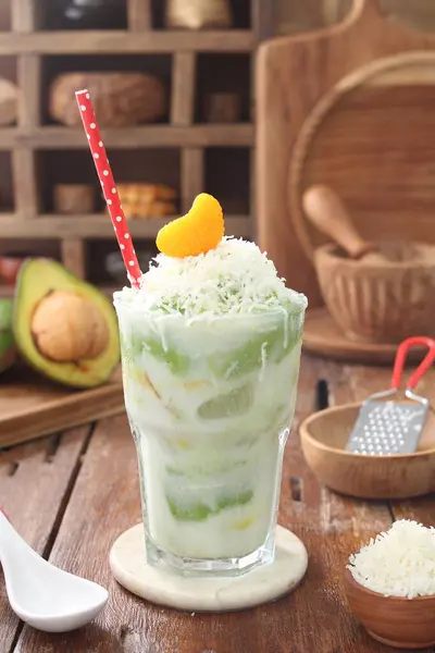 a cup of green coconut milk with ice
