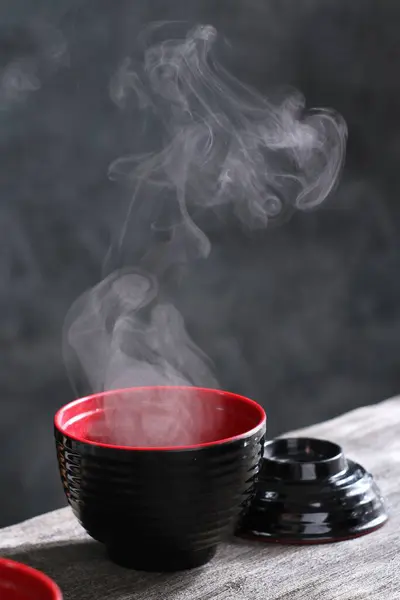 black and red tea cup with a black spoon