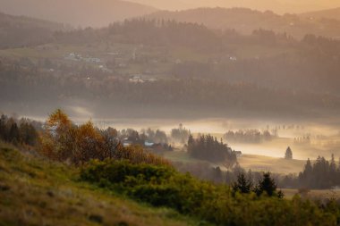 Autumn morning fog in the mountains. Autumn panorama of the Polish Beskid Mountains. Autumn landscapes in Poland. Travel photography. Wall decorations