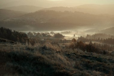 Autumn morning fog in the mountains. Autumn panorama of the Polish Beskid Mountains. Autumn landscapes in Poland. Travel photography. Wall decorations