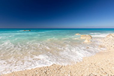 Megali Petra beach, holiday seascape overlooking a wild beach with rocks in the azure Ionian Sea, on the Greek island of Lefkada, background for design, wallpaper clipart