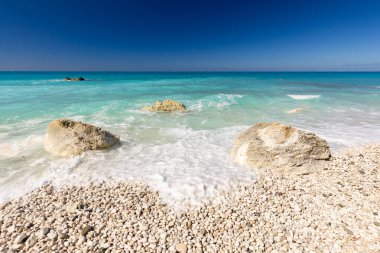 Megali Petra beach, holiday seascape overlooking a wild beach with rocks in the azure Ionian Sea, on the Greek island of Lefkada, background for design, wallpaper clipart