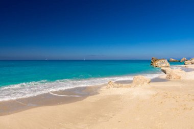 Megali Petra beach, holiday seascape overlooking a wild beach with rocks in the azure Ionian Sea, on the Greek island of Lefkada, background for design, wallpaper clipart