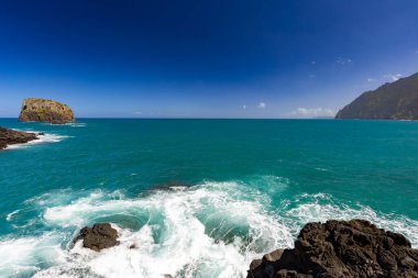 Madeira 'da (Porto da Cruz) güneşli güzel bir günde dalgalı deniz manzarası, projeniz için arka plan ya da duvar kağıdı