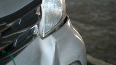 close-up view of car bumper was dented from being hit