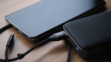 smartphone and power bank charger on a table