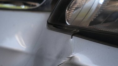 close-up view of car bumper was dented from being hit