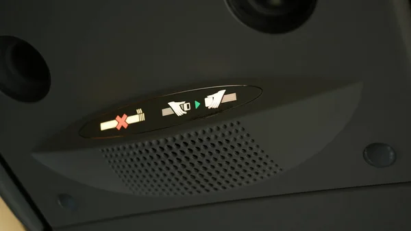Cabin sign light of no smoking and fasten seatbelt while airplane take off and landing.