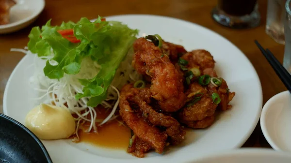 Chicken Karage with mayonaise sauce on white plate. Japanese food.