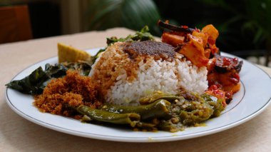 Vegetarian Padang rice on a white plate. Indonesia Vegetarian food. Namy House vegetarian.