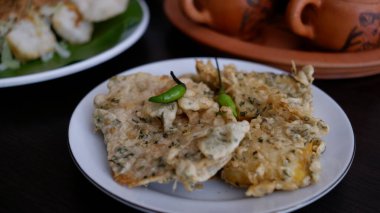 Tempe Geplung or Tempe Mendoan on a white plate. Indonesia food.