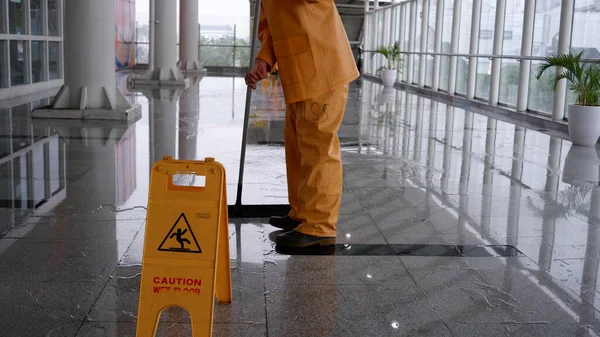 Yellow caution wet floor sign at MRT station - Image of danger, cleaning in progress at public space. Jakarta, 9 April 2022.