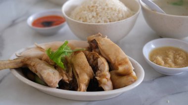 Hainanese chicken rice set on a table.