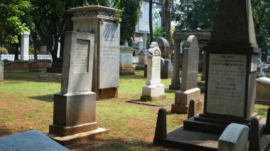 shuffling of tombstones from the Dutch era. Prasasti Museum, Jakarta. 22 February 2023.