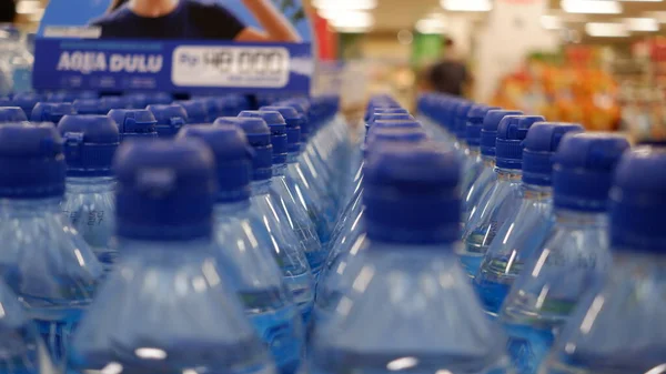 arrangement of mineral water bottles in a supermarket