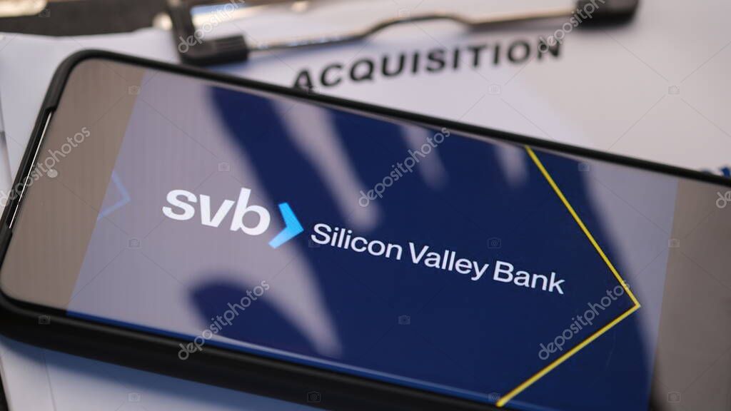 Silicon Valley Bank with hand shadows on acquisition documents. Acquisition illustration. Jakarta, 28 march 2023.