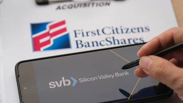 Silikon Vadisi Bankası 'nda First Citizens Bancshare' un satın alma kağıtları ve elinde kalemle. Edinim illüstrasyonu. Jakarta, 28 Mart 2023.