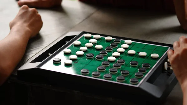 Reversi is a strategy board game for two players, played on an 88 uncheckered board. It was invented in 1883. Othello, a variant with a fixed initial setup of the board, was patented in 1971.